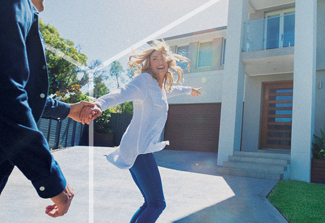 Young couple outside a house.