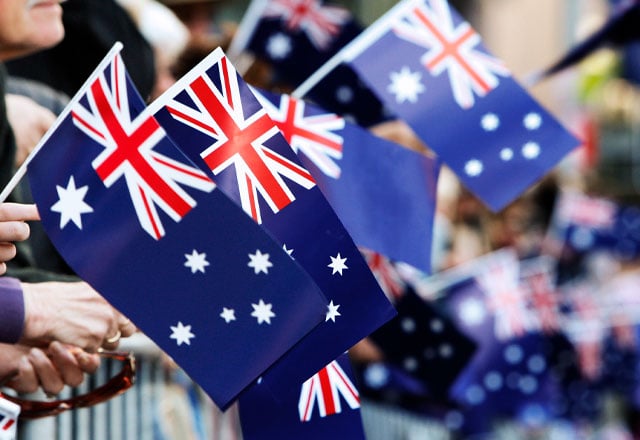 Man with Australian flag draped around him.