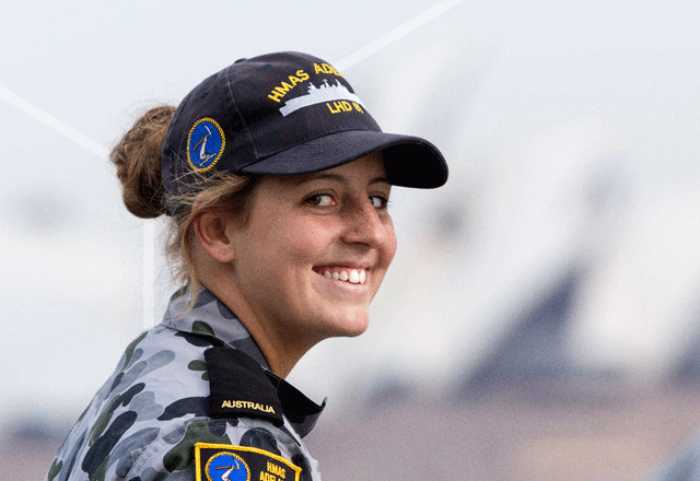 Smiling female in Navy uniform.