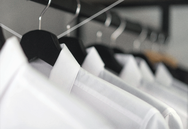 White shirts hanging on rail.