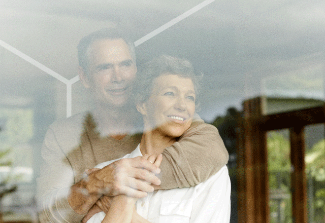 Older couple looking out window.