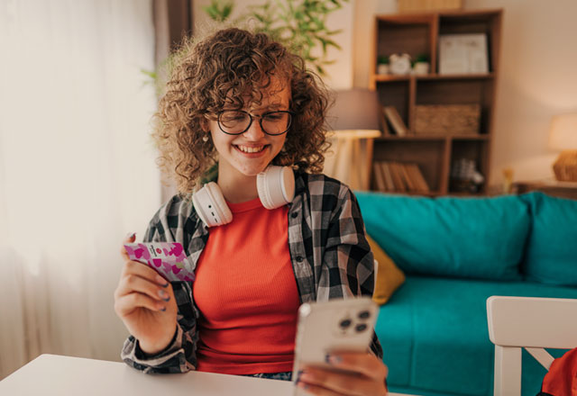 Group of people leaning against a wall.