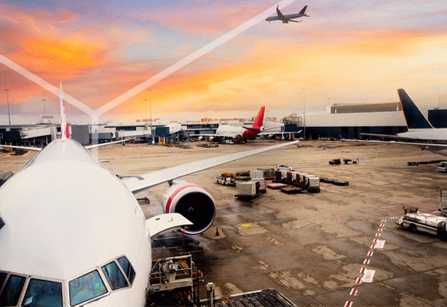 Planes sitting on airport tarmac