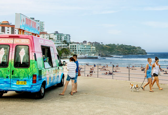 Ice cream truck serving customers at the beach