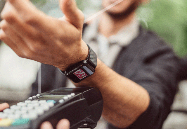 Man paying using his smart watch.