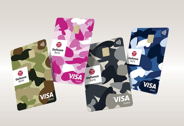 The four Visa Debit card camo designs with the pink version at the forefront against a yellow background.