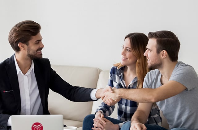 Couple on couch meeting a home loan consultant.